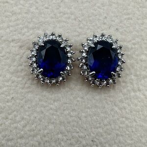 Elegant Sapphire Blue oval Stud Earrings surrounded by white crystals